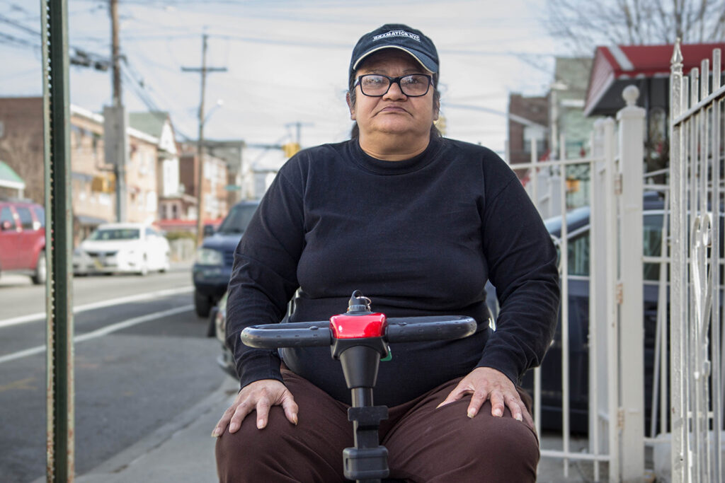 a person on a mobility scooter on the sidewalk
